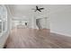 Open-concept living space with luxury vinyl plank flooring and kitchen in background at 3330 Hillshire Dr, Cumming, GA 30028