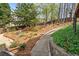 Garden path through lush landscaping, with a stone wall at 4840 Brent Knoll Ln, Suwanee, GA 30024
