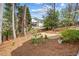 Expansive backyard with a wooden fence and mature trees at 4840 Brent Knoll Ln, Suwanee, GA 30024