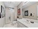Bathroom featuring tiled floor, white vanity, glass shower and decorative wall art at 4840 Brent Knoll Ln, Suwanee, GA 30024