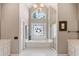 Serene bathroom with a soaking tub, stained glass window, and dual vanities at 4840 Brent Knoll Ln, Suwanee, GA 30024
