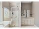 Bright bathroom featuring a glass shower with decorative window and white vanity at 4840 Brent Knoll Ln, Suwanee, GA 30024