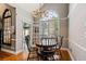 Charming dining area featuring a decorative window, hardwood floors, and stylish chandelier at 4840 Brent Knoll Ln, Suwanee, GA 30024