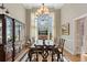 Spacious dining room with a large window, elegant chandelier, and hardwood floors at 4840 Brent Knoll Ln, Suwanee, GA 30024