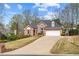 Charming brick house with an attached garage and a long driveway at 4840 Brent Knoll Ln, Suwanee, GA 30024