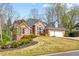 Charming brick home featuring an attached garage and a beautifully landscaped front yard at 4840 Brent Knoll Ln, Suwanee, GA 30024
