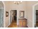 Foyer featuring hardwood flooring, framed art, neutral walls, and views into other rooms at 4840 Brent Knoll Ln, Suwanee, GA 30024