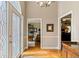 Sunlit foyer with hardwood flooring, sidelight windows, and views to multiple living areas at 4840 Brent Knoll Ln, Suwanee, GA 30024