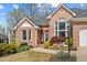 Lovely brick home with manicured landscaping, a brick walkway, and a pretty front door at 4840 Brent Knoll Ln, Suwanee, GA 30024