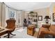 Living room with a comfortable seating area, natural lighting, and modern decor at 4840 Brent Knoll Ln, Suwanee, GA 30024