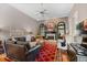 Spacious living room with fireplace, hardwood floors, and comfortable seating area at 4840 Brent Knoll Ln, Suwanee, GA 30024