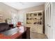 Office room with wooden desk, bookshelf, and closet with panel doors at 4840 Brent Knoll Ln, Suwanee, GA 30024