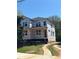 Exterior view of a new home under construction showing windows and Tyvek home wrap with driveway and landscaping at 1236 Oakland Sw Ter # A, Atlanta, GA 30310