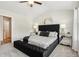 The primary bedroom features a stylish upholstered headboard, ceiling fan, and neutral decor at 6355 Towhee Way, Morrow, GA 30260