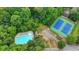 A community view featuring a pool, tennis courts, and mature trees at 910 Brentwood Ave, Lawrenceville, GA 30044