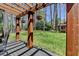 Backyard featuring a wooden pergola, a lawn and a small red playhouse at 910 Brentwood Ave, Lawrenceville, GA 30044