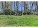 Expansive backyard with lush green grass and a charming red playhouse at 910 Brentwood Ave, Lawrenceville, GA 30044
