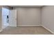 Neutral basement with carpet and a door to a storage area, and a closet rod at 910 Brentwood Ave, Lawrenceville, GA 30044