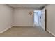 Neutral basement with carpet, an open door to stairs, and a utility clock at 910 Brentwood Ave, Lawrenceville, GA 30044