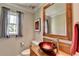 Stylish bathroom with a vessel sink, decorative mirror, and a window with natural light at 910 Brentwood Ave, Lawrenceville, GA 30044
