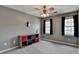 Modern bedroom featuring neutral gray walls, ample natural light from two windows and a decorative storage unit at 910 Brentwood Ave, Lawrenceville, GA 30044