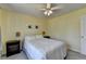 Bright bedroom with a comfortable bed, side tables, and a window with natural light, freshly painted in yellow at 910 Brentwood Ave, Lawrenceville, GA 30044
