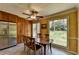 Bright dining area with a wooden table, large windows offering backyard views, and a ceiling fan at 910 Brentwood Ave, Lawrenceville, GA 30044