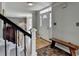 A lovely foyer featuring hardwood floors, staircase, and a traditional entryway bench at 910 Brentwood Ave, Lawrenceville, GA 30044