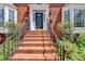 Inviting brick staircase leads to a beautiful front door flanked by bay windows and manicured landscaping at 910 Brentwood Ave, Lawrenceville, GA 30044