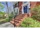 Charming brick front with a welcoming entryway, complete with a wrought-iron railing and lush greenery at 910 Brentwood Ave, Lawrenceville, GA 30044