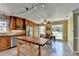 Eat-in kitchen with wood cabinets, stainless steel appliances, and a breakfast table near large windows at 910 Brentwood Ave, Lawrenceville, GA 30044