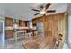 A well-lit eat-in kitchen featuring wood cabinets, stainless steel appliances, and center wooden work table at 910 Brentwood Ave, Lawrenceville, GA 30044