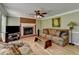 Cozy living room featuring a brick fireplace, hardwood floors, and comfortable seating at 910 Brentwood Ave, Lawrenceville, GA 30044