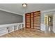 Stylish living area featuring hardwood floors, custom built-in shelving, and a cozy ambiance at 910 Brentwood Ave, Lawrenceville, GA 30044