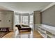 Bright living room with hardwood floors, stylish chaise lounge, and large bay window offering ample natural light at 910 Brentwood Ave, Lawrenceville, GA 30044