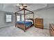 This main bedroom features a wooden canopy bed frame, dresser, ceiling fan and plenty of natural light at 910 Brentwood Ave, Lawrenceville, GA 30044