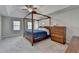 This main bedroom features a wooden canopy bed frame, dresser, ceiling fan and two windows at 910 Brentwood Ave, Lawrenceville, GA 30044
