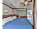 This main bedroom features a wooden canopy bed frame, dresser, ceiling fan and a door leading to the bathroom at 910 Brentwood Ave, Lawrenceville, GA 30044
