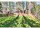 A spacious backyard with vibrant green grass with lush greenery behind the house at 1309 Brookshire Ne Ln, Brookhaven, GA 30319