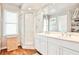 Bathroom featuring a double sink vanity, glass shower, and storage at 1309 Brookshire Ne Ln, Brookhaven, GA 30319