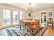 Open-concept dining area with wooden table and outdoor access at 1309 Brookshire Ne Ln, Brookhaven, GA 30319