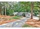 View of the exterior with an extended driveway and a lush lawn at 1309 Brookshire Ne Ln, Brookhaven, GA 30319