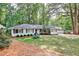 Charming ranch-style home with a lush green lawn, mature trees, and inviting curb appeal at 1309 Brookshire Ne Ln, Brookhaven, GA 30319