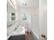 Bathroom with vanity and sink, with bath and shower and two windows at 1323 Christmas Ne Ln, Atlanta, GA 30329