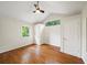 Vaulted bedroom featuring hardwood floors, white walls, and lots of natural light from two windows at 1323 Christmas Ne Ln, Atlanta, GA 30329