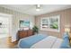 Bright bedroom with a ceiling fan, hardwood floors, and a double-hung window overlooking the front yard at 1323 Christmas Ne Ln, Atlanta, GA 30329