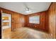 Bedroom with wood paneled walls, hardwood floors, window, and ceiling fan at 1323 Christmas Ne Ln, Atlanta, GA 30329