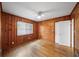 Charming bedroom features wood paneled walls, hardwood floors, window, and ceiling fan at 1323 Christmas Ne Ln, Atlanta, GA 30329