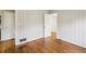 Bedroom with a connecting door, hardwood floors, and a double-hung window with blinds at 1323 Christmas Ne Ln, Atlanta, GA 30329
