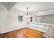 Bright dining area featuring hardwood floors, a chandelier, and a large window, creating an inviting space at 1323 Christmas Ne Ln, Atlanta, GA 30329